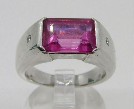 Boodles &amp; Dunthorne. An 18ct white gold dress ring, centred with a 4.09ct emerald-cut pink rubellite tourmaline, in ‘supe