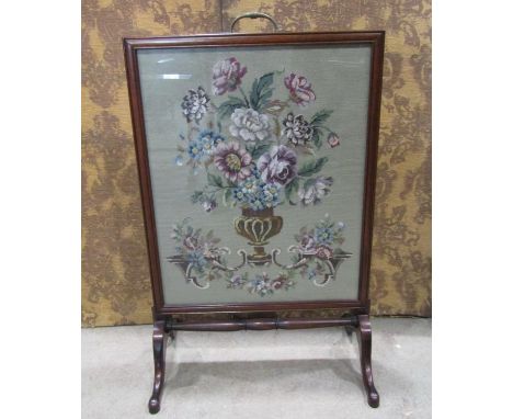A late 19th century mahogany framed firescreen with hand worked tapestry panel raised on shaped supports, 60cm wide x 91cm hi