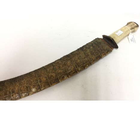 Indian made curved short sword. Bone handle. Etched 57cm blade with designs of snakes. Complete with scabbard covered with Cr