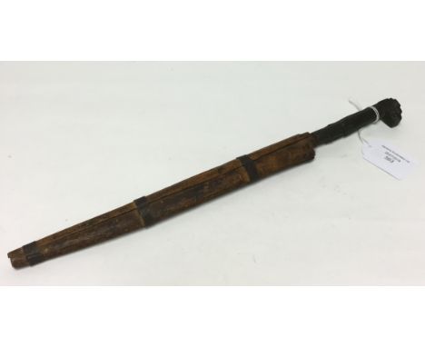 An Africa dagger with 250mm long decorated single edge blade complete in wooden scabbard.