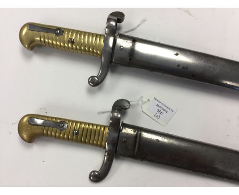 A pair of French 1866 Pattern Chassepot bayonets. Non matching numbers. Complete with scabbards. One missing hanger loop from