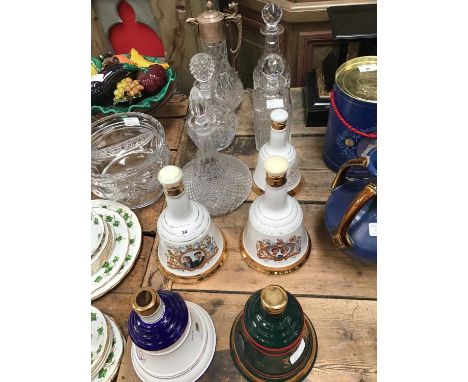 A pair of commemorative porcelain decanters from Bell's Scotch Whiskey in celebration of royal weddings, together with three 