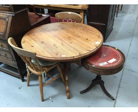 Pine circular breakfast table on tripod base, two pine kitchen chairs and drum table .