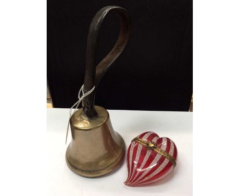 Victorian brass school bell with leather handle, together with a Victorian red and white glass heart shaped trinket box (2)