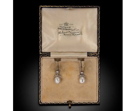 A pair of natural pearl and diamond ear pendants, each set with a flattened oval natural saltwater pearl, surmounted by five 