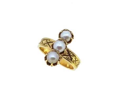 A pearl ring, three claw set half drilled off-round pearls, approximate diameter 4mm, full width carved shoulders, flat shank