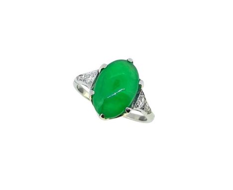 An Art Deco jade and diamond ring, claw set oval shaped cabochon jade, approximately 12.1 x 8mm, tapered shoulders with gradu