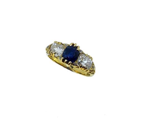 A sapphire and diamond carved half hoop ring, central claw set oval faceted sapphire, approximately 6.2 x 5.15mm, estimated a