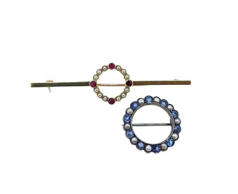 Two circular brooches, first, a bar style brooch with a central pierced circle set with four round faceted rubies and twelve 