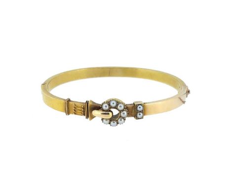 A Victorian split pearl hinged bangle, plain polished with a split pearl buckle motif, and applied wire decoration to one sid