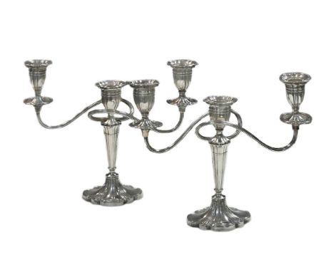 Two mid 20th century silver three light candelabra, mark of A. Edward Jones Ltd., Birmingham 1966 &amp; 1968, of matching des