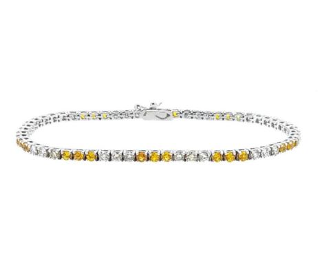A yellow sapphire and diamond line bracelet, alternate sections of three round faceted yellow sapphires and three round brill