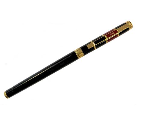 Cartier/Yves St. Laurent - A two-colour lacquered rollerball pen, circa 1988, black lacquered body with gold coloured detaili