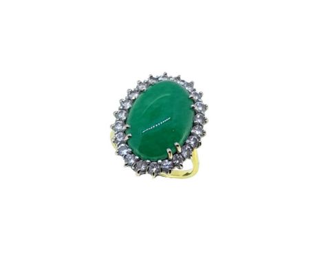 An 18ct gold jade and diamond cluster ring, claw set oval shaped cabochon jade, approximately 18 x 13mm, surrounded by twenty