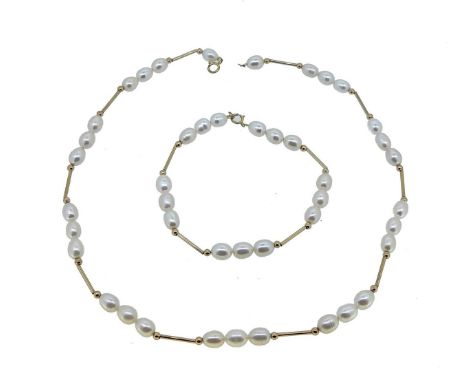 A pearl necklace and bracelet suite, the necklace with nine sections each of three freshwater pearls, separated by yellow met