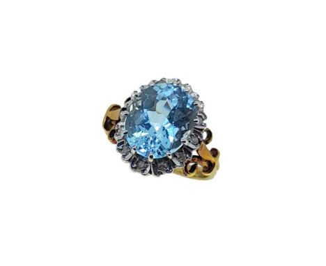 A late 20th century aquamarine and diamond cluster ring, claw set oval faceted aquamarine, approximately 11.1 x 9.2mm, estima