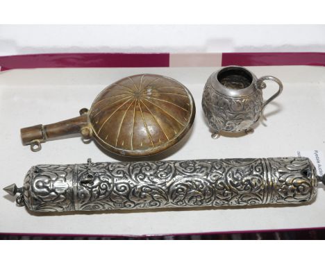 White metal heavily embossed scroll holder marked Dubar, small white metal relief moulded tankard on three feet with elephant