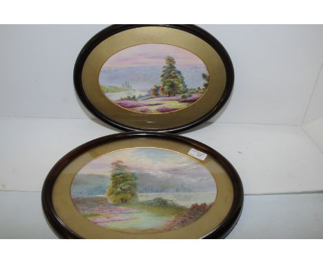 Pair of oval framed painted ceramic panels depicting woodland scenes with river to foreground