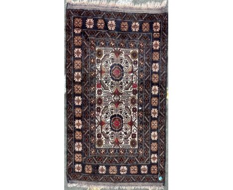 A vintage mid 20th Century Caucasic Kazak floor carpet rug. Having central panel with stylized floral patterns encapsulated w