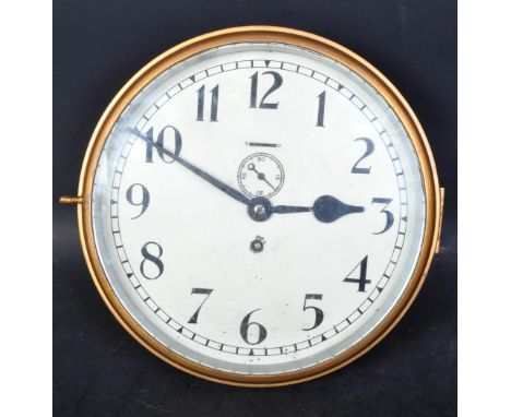 A vintage 20th Century brass station office railway clock. With circular round face with hinged lid, ebonised hands and chapt