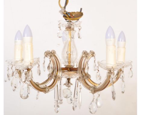 A 20th century cut glass and gilt metal classical 5 arm chandelier. The shaped gilt metal frame set with 5 arms wrapped in a 