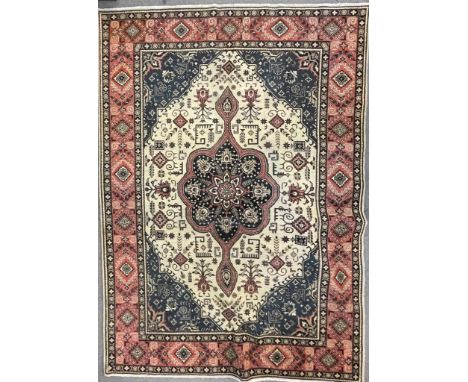 An early 20th century Northwest Persian Islamic Tabriz floor carpet rug having a flower shaped central medallion within a cre