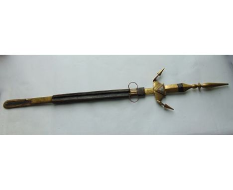 An unusual large antique eastern sword, the extensive angular brass handle with incised detail and further white metal and co