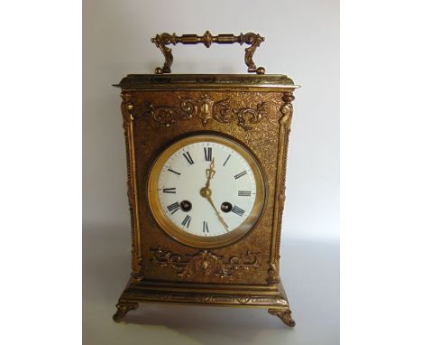 A 19th century French bracket clock, the brass case with chased decoration and further overlaid detail, with enamelled dial a