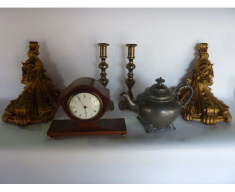 An Edwardian mantle clock with shaped outline with string inlay, principally in mahogany with white enamelled dial, raised on