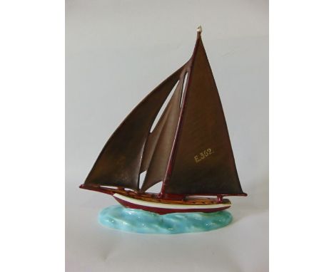 A Czechoslovakian model of a sailing yacht raised on an oval base, with printed mark Ditmar Urbach