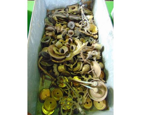 A vintage industrial aluminium tray of rectangular form with looping handles containing an assortment of brass sconces and ot