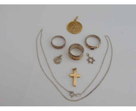 A 9ct gold St. Christopher pendant medallion, 4g; a 9ct gold crucifix pendant, 2.2g; an 18ct gold and silver ring, with scrol