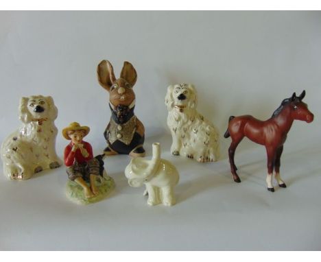 A Beswick matt glazed model of a standing brown foal together with a pair of Beswick models of seated white glazed spaniels, 