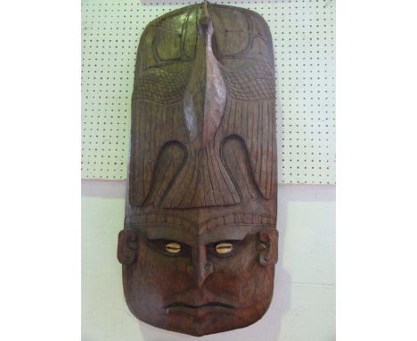 A substantial carved timber mask/panel of rectangular form, believed to Papuan,  the bottom portion detailing a stylised face