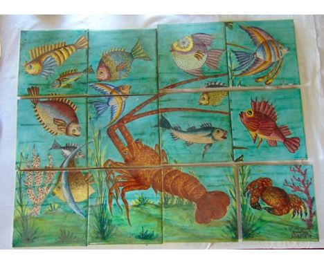 An Italian panel comprising twelve painted tiles with marine motifs including a lobster, crab, various fish, etc, signed to t