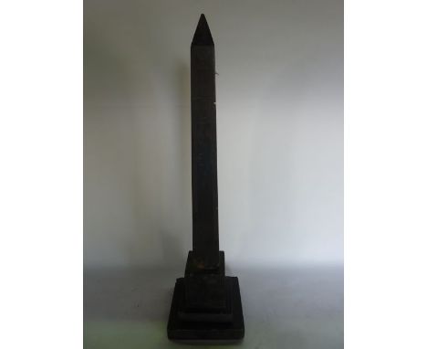 A 19th century Grand Tour worked slate model of an obelisk with extensive Egyptian hieroglyphics in low relief to one side, o