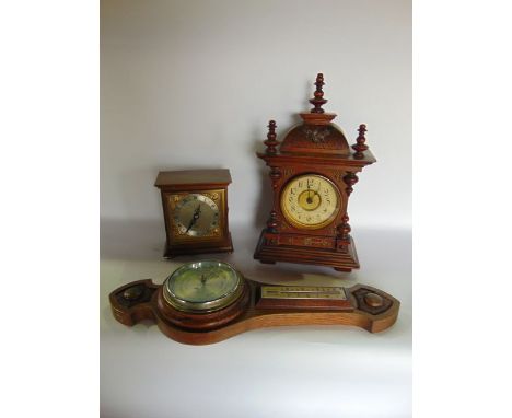 A small German bracket clock, the case with applied turned spindle mouldings enclosing an eight day timepiece together with a
