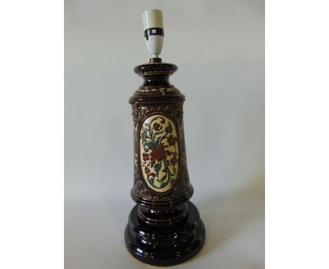 A heavy early 20th century German majolica lamp base by Gerbing & Stephan with moulded and incised floral and trailing leaf d
