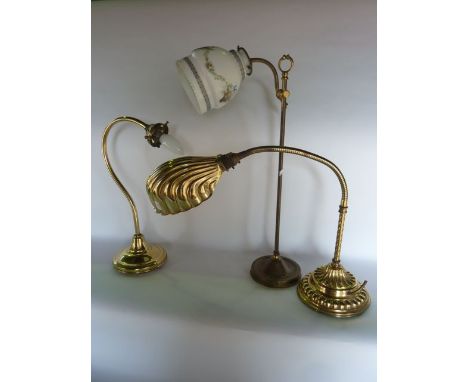 A brass electronic desk lamp with reticulated stem and fluted shade raised upon a stepped base with embossed detail, a furthe