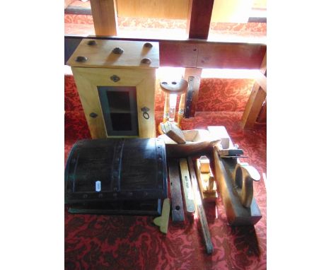 A small stained timber domed topped chest with hinged lid and applied metallic mounts, a timber framed sand timer with water 