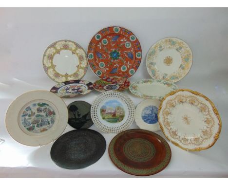 A 19th century Imari dish with alternating painted and gilded panels with floral scale and flowering tree decoration together