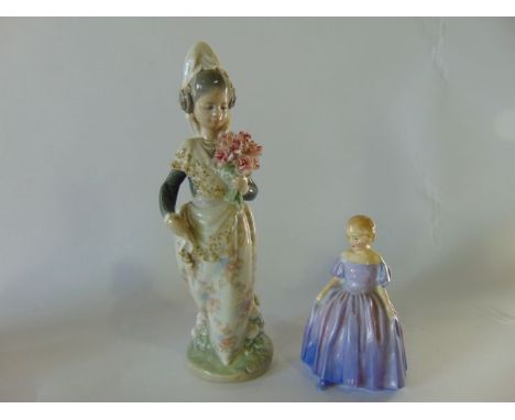 A Lladro model of a young girl in Spanish style costume holding a bunch of pink carnations