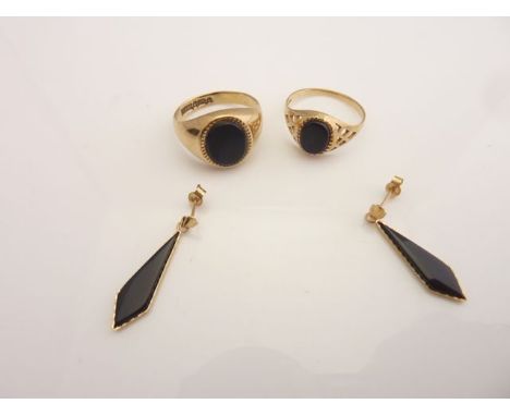 A 9ct gold signet ring, inset with an oval onyx, size K 1/2; an onyx ring, with openworked shoulders, in 9ct gold, size L; an