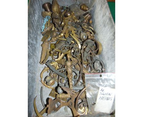 A vintage industrial aluminium tray of rectangular form with looping handles containing a quantity of brass finials and casti