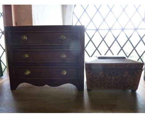 A 19th century sarcophagus shaped tea caddy, principally veneered in rose wood with extensive scrolling and floral yew wood i