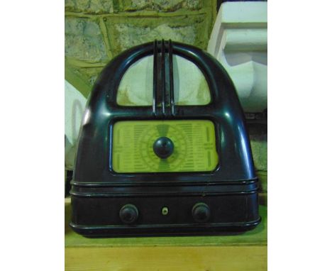 An early 20th century Bakelite cased valve radio of arched form, bearing labels to reverse - Philo Model 444, Pennell Bros We