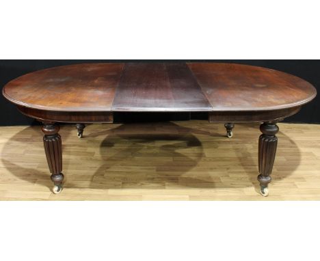 An early Victorian mahogany extending dining table, discorectangular top with moulded edge, one additional leaf, oblate spher