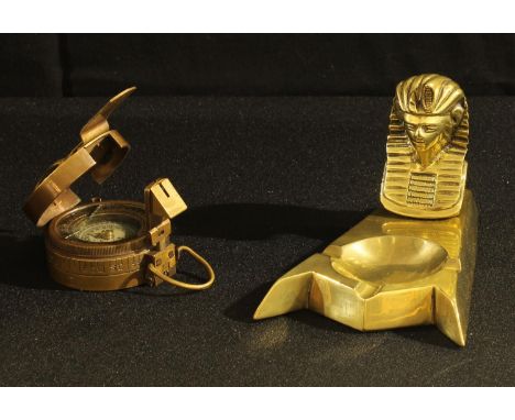 An Egyptian Revival ashtray, cast with the head of pharaoh; a World War Two style marching compass, [2] 
