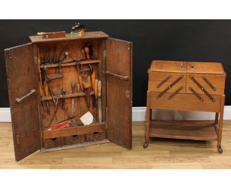 An oak bench top tool cabinet, enclosing an assortment of hand tools, including Stanley bull nose 75, files, chisels, etc, 79