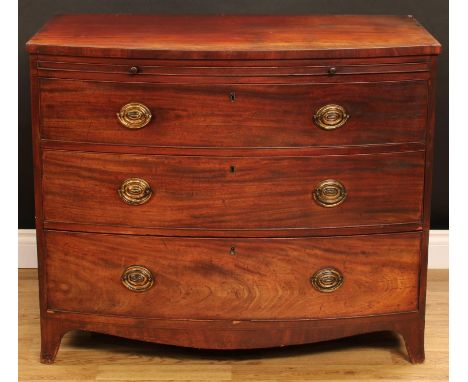 A George III mahogany bow front bachelor's chest, slightly oversailing top above a slide and three long graduated drawers, sw